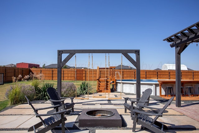 view of patio with an outdoor bar and an outdoor fire pit