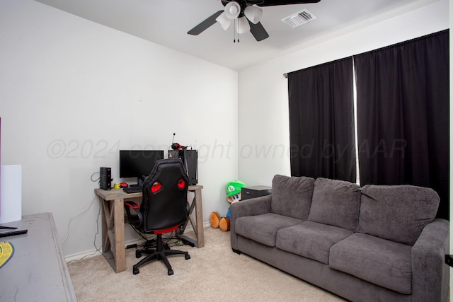 carpeted home office with ceiling fan