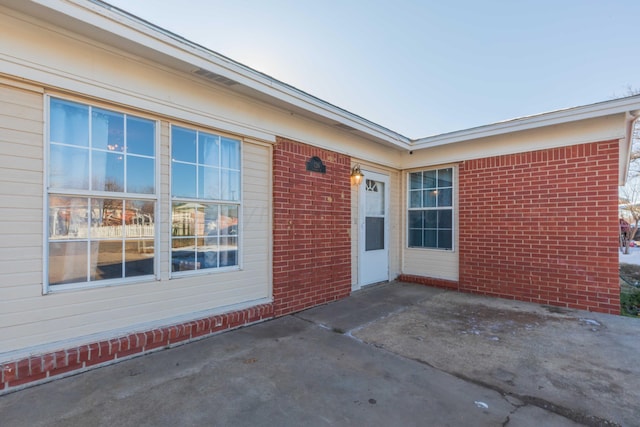 doorway to property with a patio area