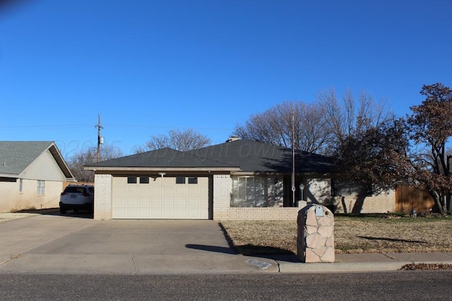 ranch-style house with a garage, concrete driveway, and brick siding