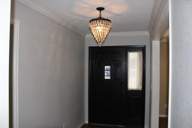 foyer featuring ornamental molding and a chandelier