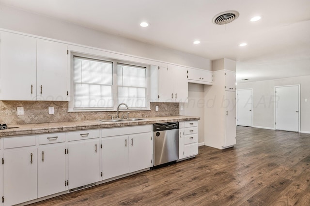 kitchen with dishwasher, a sink, white cabinetry, and visible vents