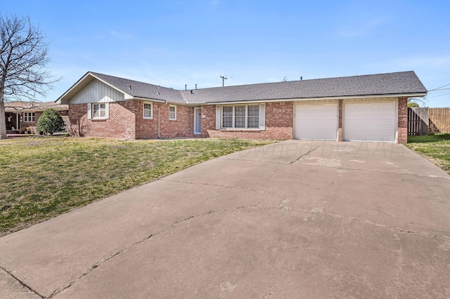 ranch-style home with fence, an attached garage, brick siding, a front lawn, and driveway
