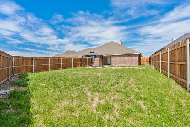 7912 Pensacola Ave, Amarillo, TX 79118 - rear view of property featuring a gazebo, brick siding, a fenced backyard, a chimney, and a patio area