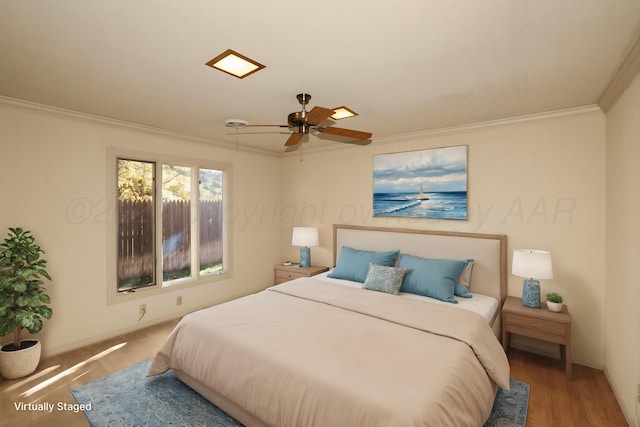 bedroom with hardwood / wood-style floors, ceiling fan, and ornamental molding