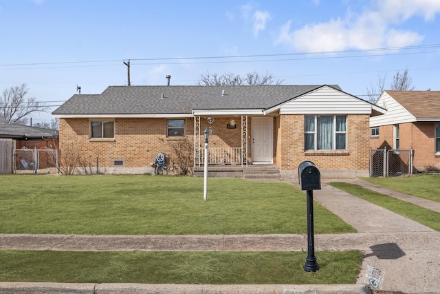 view of front of home featuring crawl space, fence, a front lawn, and brick siding