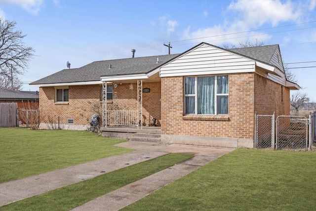 view of front of property with a front yard, fence, and brick siding