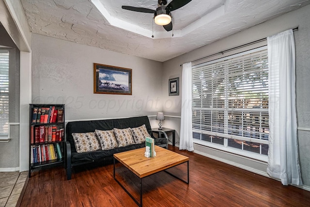 4208 Alamo Rd, Amarillo, TX 79110 - living area featuring ceiling fan, baseboards, wood finished floors, and a tray ceiling