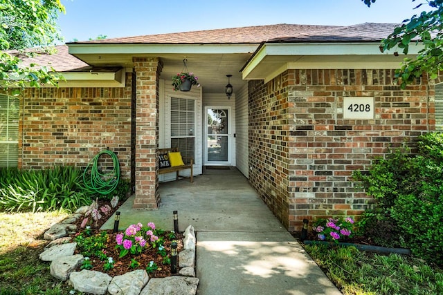 4208 Alamo Rd, Amarillo, TX 79110 - view of exterior entry with brick siding and a shingled roof