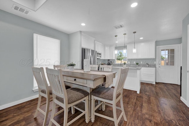 2913 Wichita Ave, Amarillo, TX 79107 - dining area featuring baseboards, dark wood finished floors, and recessed lighting