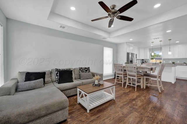 2913 Wichita Ave, Amarillo, TX 79107 - living room featuring dark wood-style floors, a ceiling fan, recessed lighting, and a raised ceiling