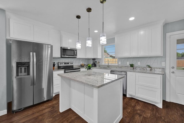 2913 Wichita Ave, Amarillo, TX 79107 - kitchen featuring stainless steel appliances, plenty of natural light, white cabinetry, dark wood-type flooring, and recessed lighting