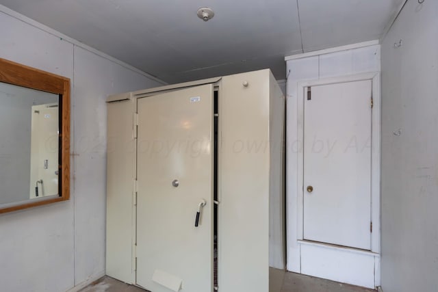 unfurnished bedroom with concrete flooring