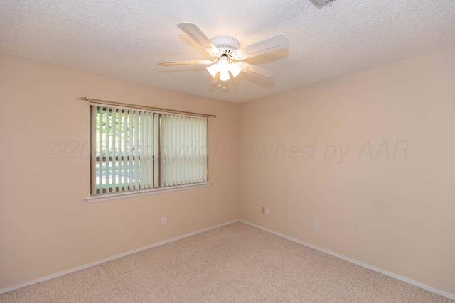 spare room featuring carpet floors, a ceiling fan, a textured ceiling, and baseboards