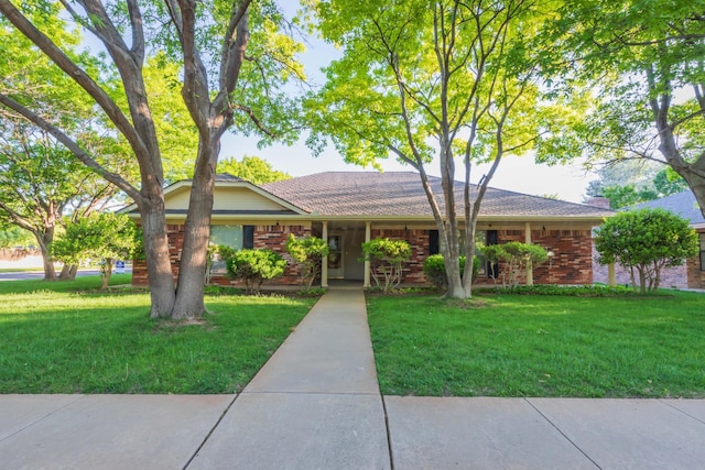 single story home featuring a front lawn and brick siding