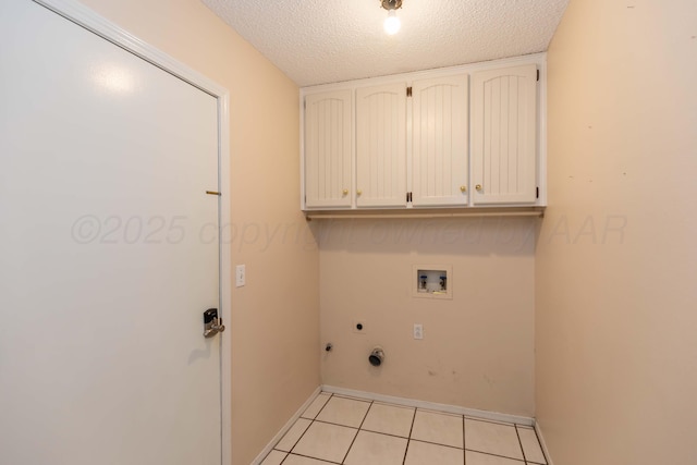 clothes washing area featuring cabinet space, washer hookup, electric dryer hookup, light tile patterned floors, and hookup for a gas dryer