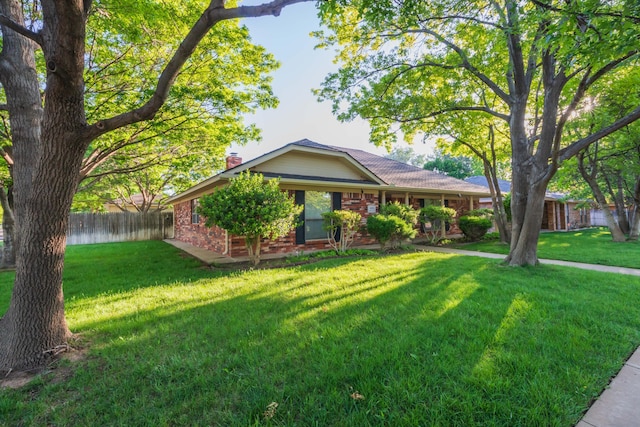 single story home with brick siding and a chimney