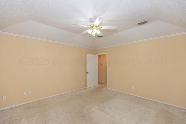 empty room featuring light carpet, ceiling fan, ornamental molding, baseboards, and a raised ceiling