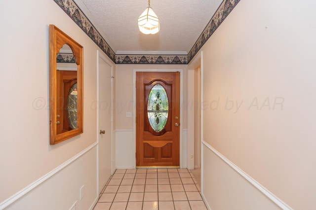 doorway with a textured ceiling and light tile patterned floors