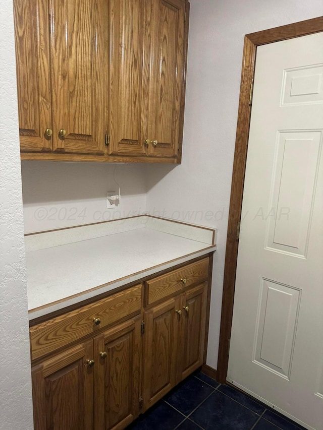 kitchen featuring dark tile patterned flooring