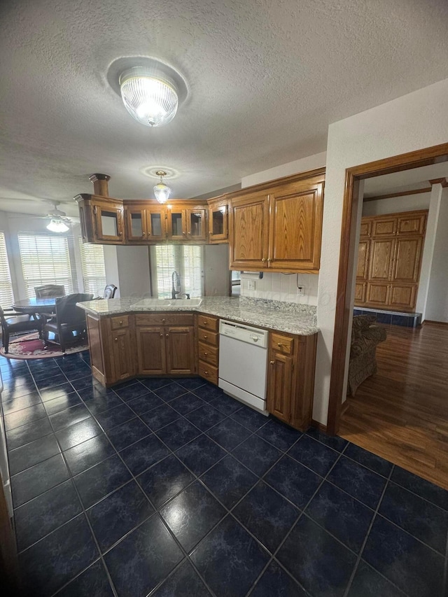 kitchen with kitchen peninsula, light stone countertops, a textured ceiling, dark wood-type flooring, and dishwasher