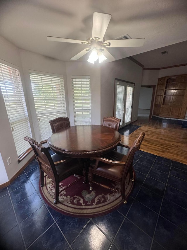 dining space featuring ceiling fan, dark tile patterned floors, and french doors