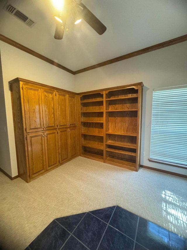 interior space with ceiling fan, light colored carpet, and ornamental molding