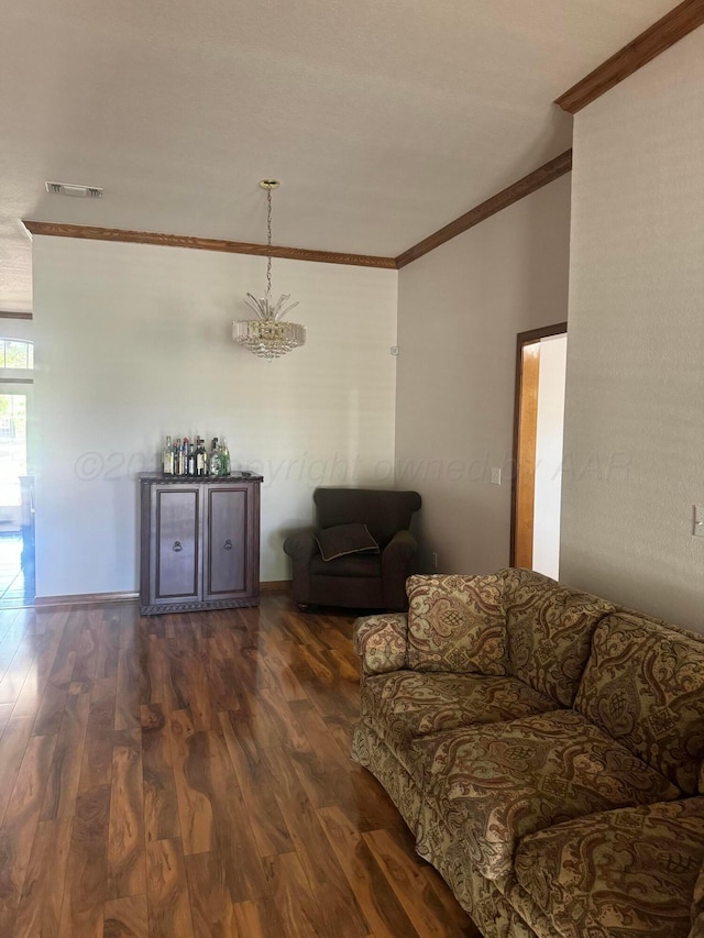 unfurnished living room with a chandelier, dark hardwood / wood-style flooring, and crown molding