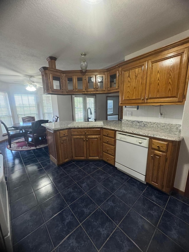 kitchen with dishwasher, ceiling fan, kitchen peninsula, and a healthy amount of sunlight