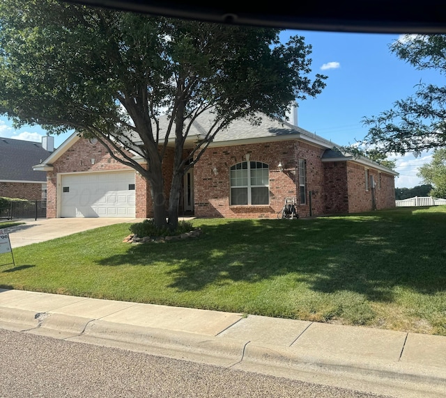 ranch-style home with a front yard and a garage