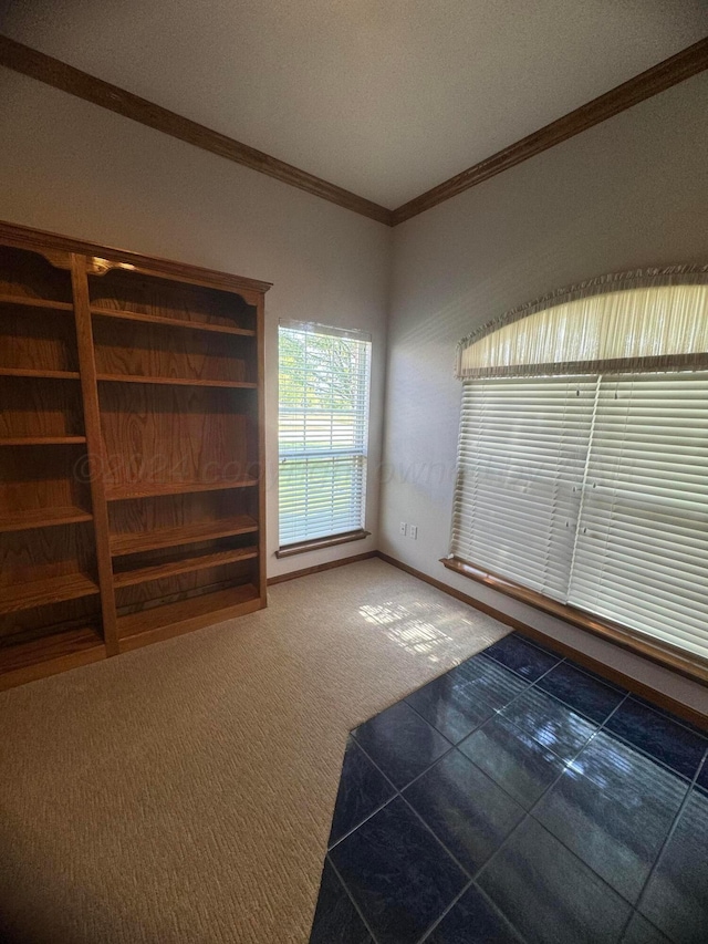 unfurnished living room with dark carpet and ornamental molding