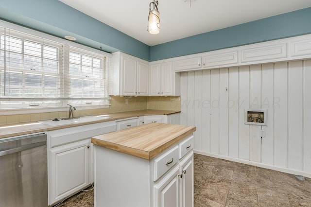 kitchen with a sink, white cabinetry, wooden counters, backsplash, and dishwasher