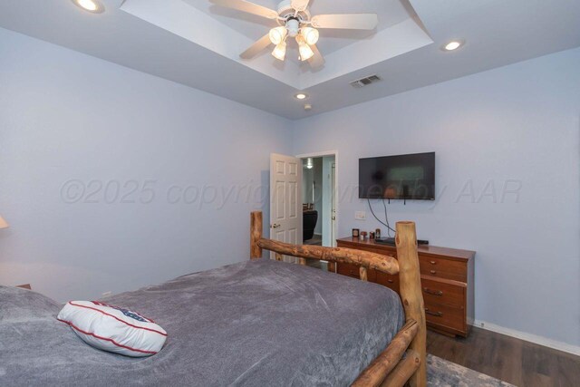 6205 S Bonham St, Amarillo, TX 79118 - bedroom featuring dark wood-style flooring, recessed lighting, a tray ceiling, and a ceiling fan