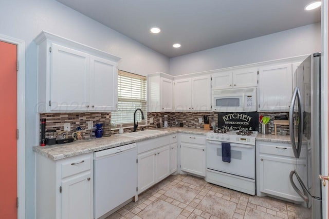6205 S Bonham St, Amarillo, TX 79118 - kitchen with white appliances, white cabinets, backsplash, light countertops, and recessed lighting