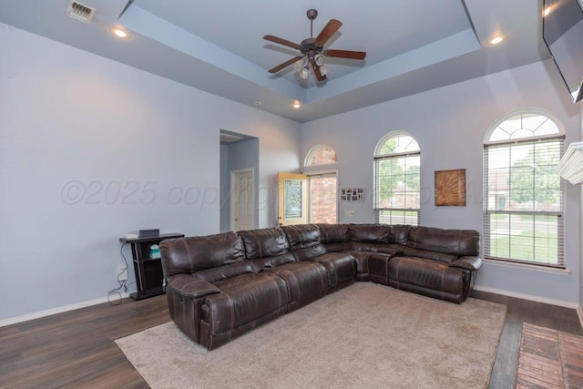 6205 S Bonham St, Amarillo, TX 79118 - living room with dark wood finished floors, a ceiling fan, a raised ceiling, and recessed lighting