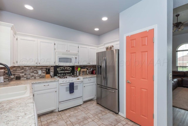 6205 S Bonham St, Amarillo, TX 79118 - kitchen featuring white appliances, tasteful backsplash, light countertops, white cabinetry, and recessed lighting