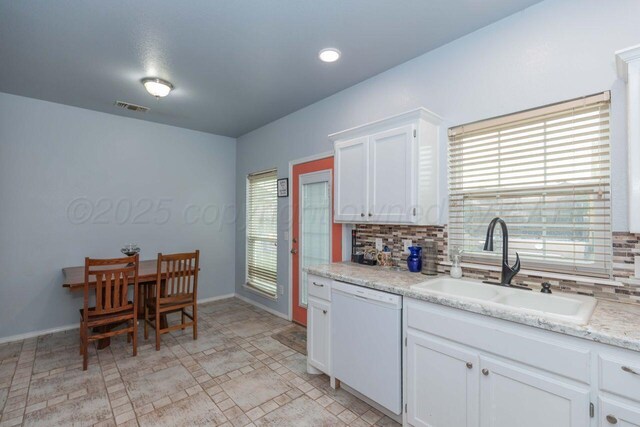 6205 S Bonham St, Amarillo, TX 79118 - kitchen with dishwasher, tasteful backsplash, healthy amount of natural light, and white cabinets