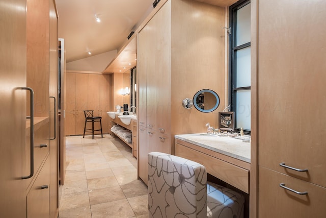 bathroom featuring vanity and vaulted ceiling