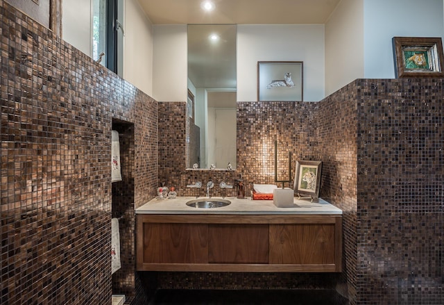 bathroom with vanity and tasteful backsplash