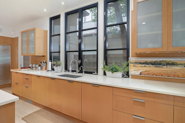 kitchen featuring light brown cabinets, sink, and high end fridge