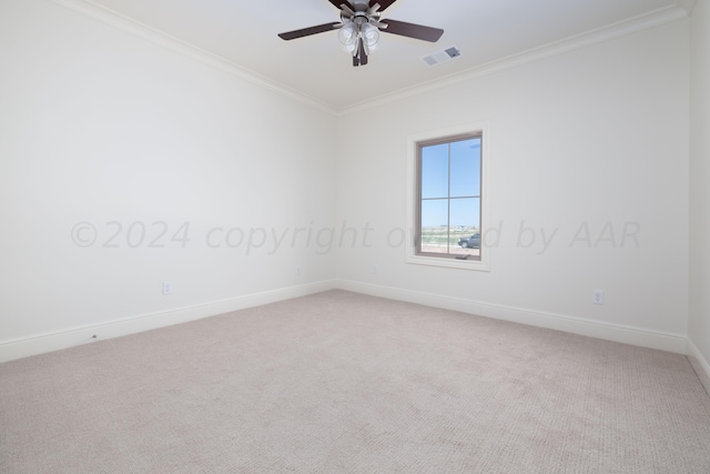 empty room featuring visible vents, ornamental molding, light carpet, baseboards, and a ceiling fan