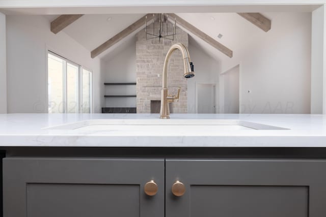 details featuring a sink and beam ceiling