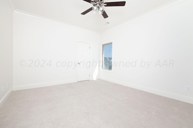 unfurnished room featuring crown molding, carpet floors, baseboards, and a ceiling fan