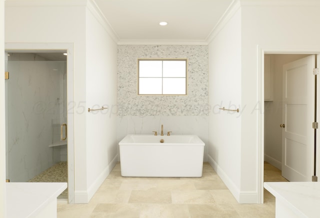 bathroom with crown molding, a freestanding tub, baseboards, and a stall shower