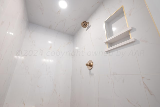 details featuring a marble finish shower