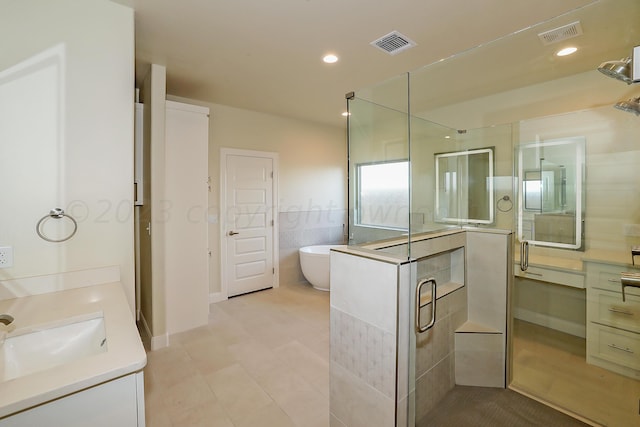 bathroom featuring vanity and plus walk in shower