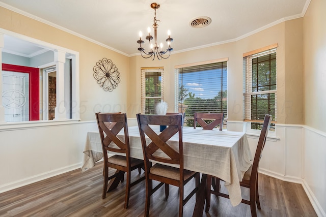 6308 Dartmouth St, Amarillo, TX 79109 - dining space featuring wood finished floors, plenty of natural light, a chandelier, wainscoting, and ornamental molding