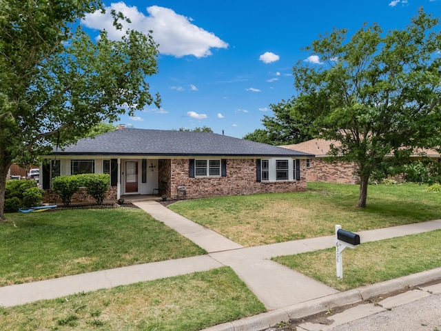 6308 Dartmouth St, Amarillo, TX 79109 - ranch-style house with a front lawn, brick siding, and a shingled roof