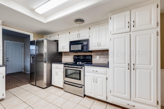 6308 Dartmouth St, Amarillo, TX 79109 - kitchen with stainless steel appliances, dark countertops, white cabinets, and backsplash