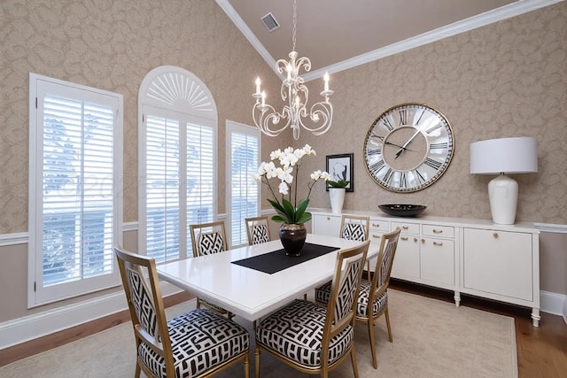 dining room featuring a chandelier, plenty of natural light, light wood finished floors, and wallpapered walls